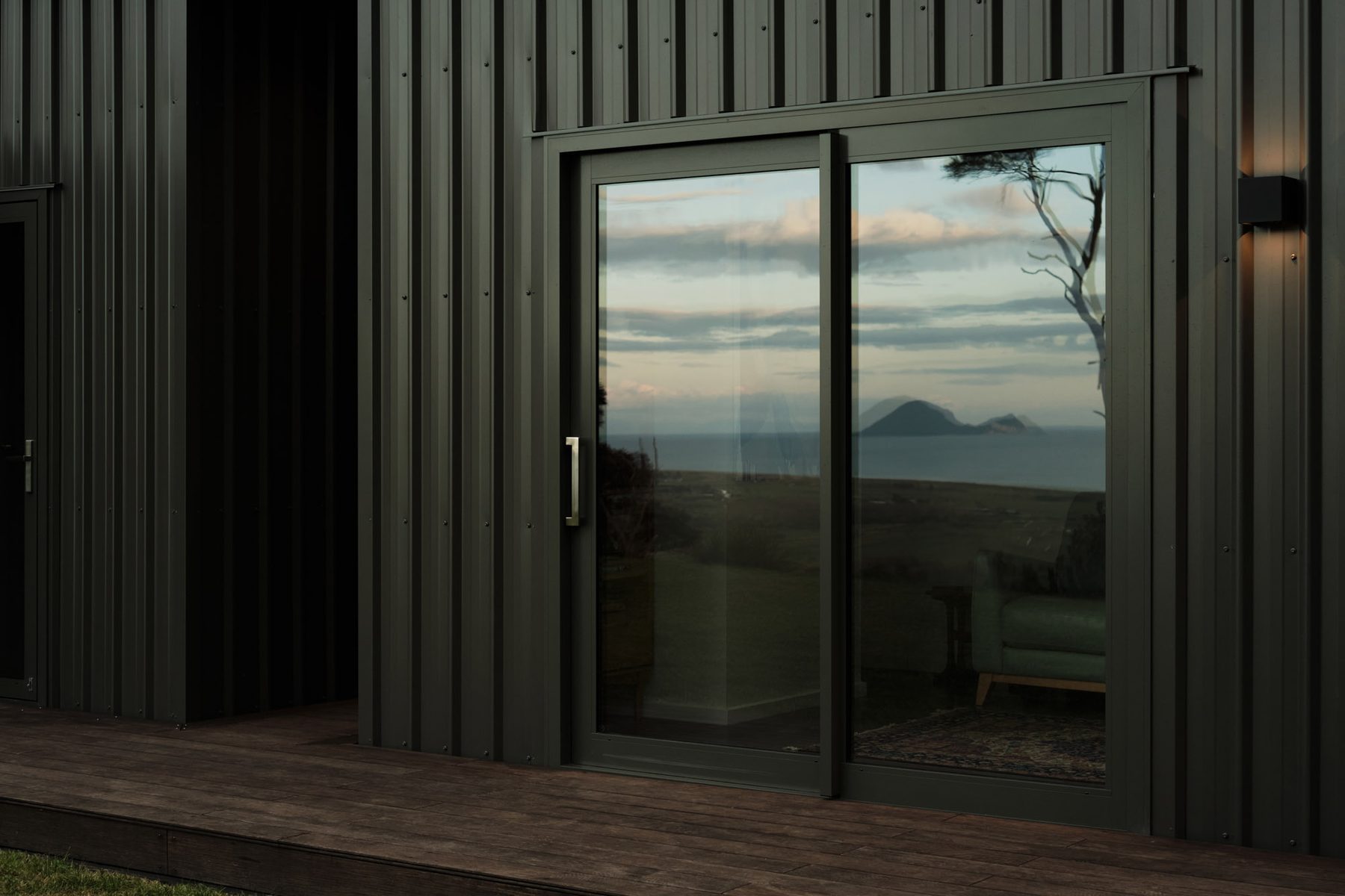 Moutohorā Whale Island reflected in the sliding glass.