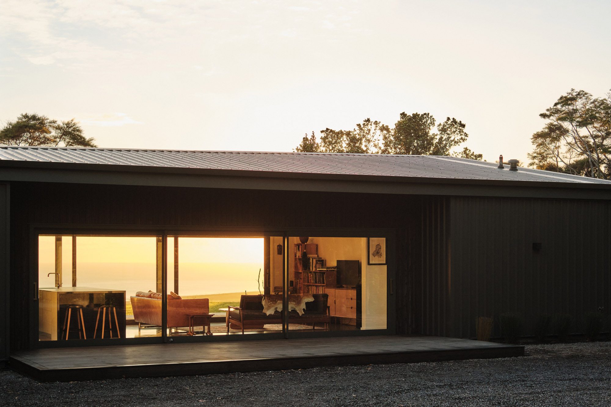 Exterior: south elevation at sunrise with golden light