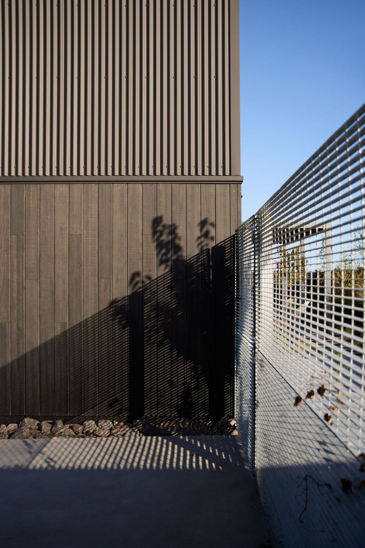 Batten screen drawing shadows on timber.