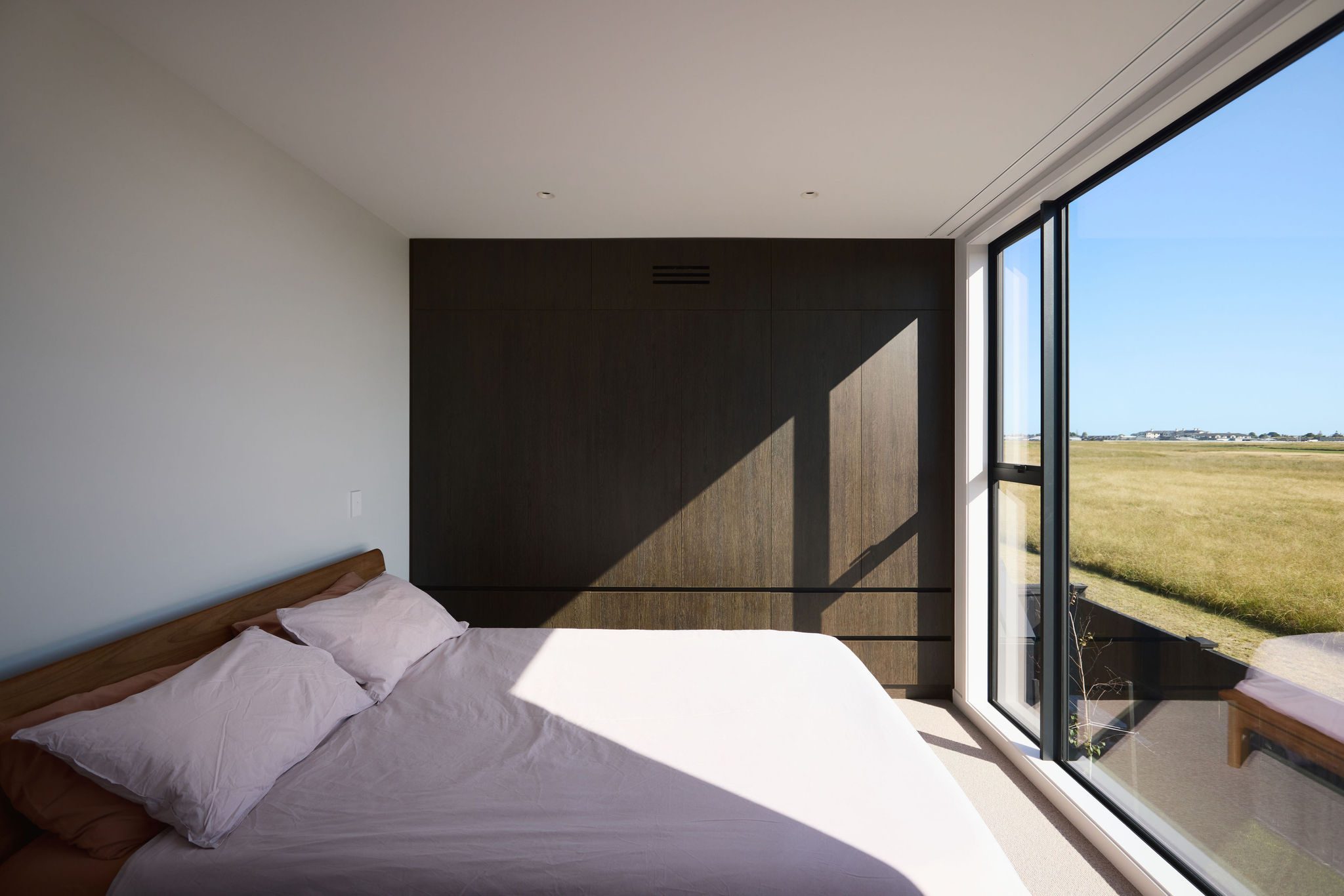 Bedroom with large window and view of the natural reserve