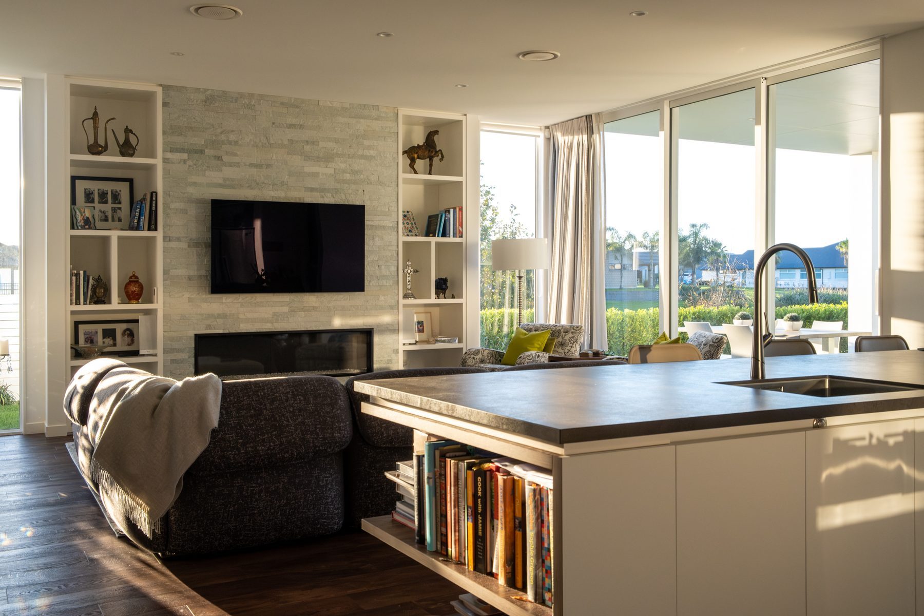 Open living with full-height glazing to the view.