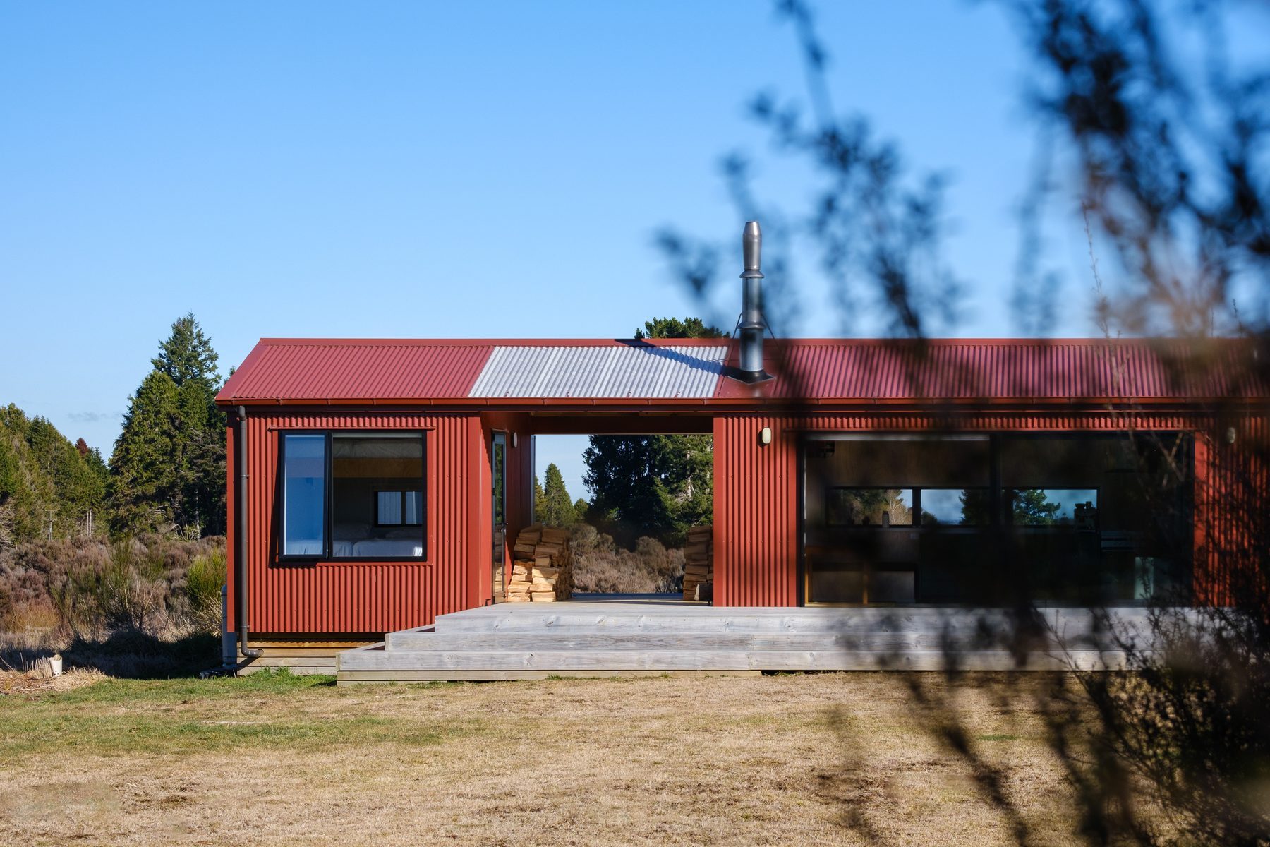 The long elevation, entrance porch and red roof.
