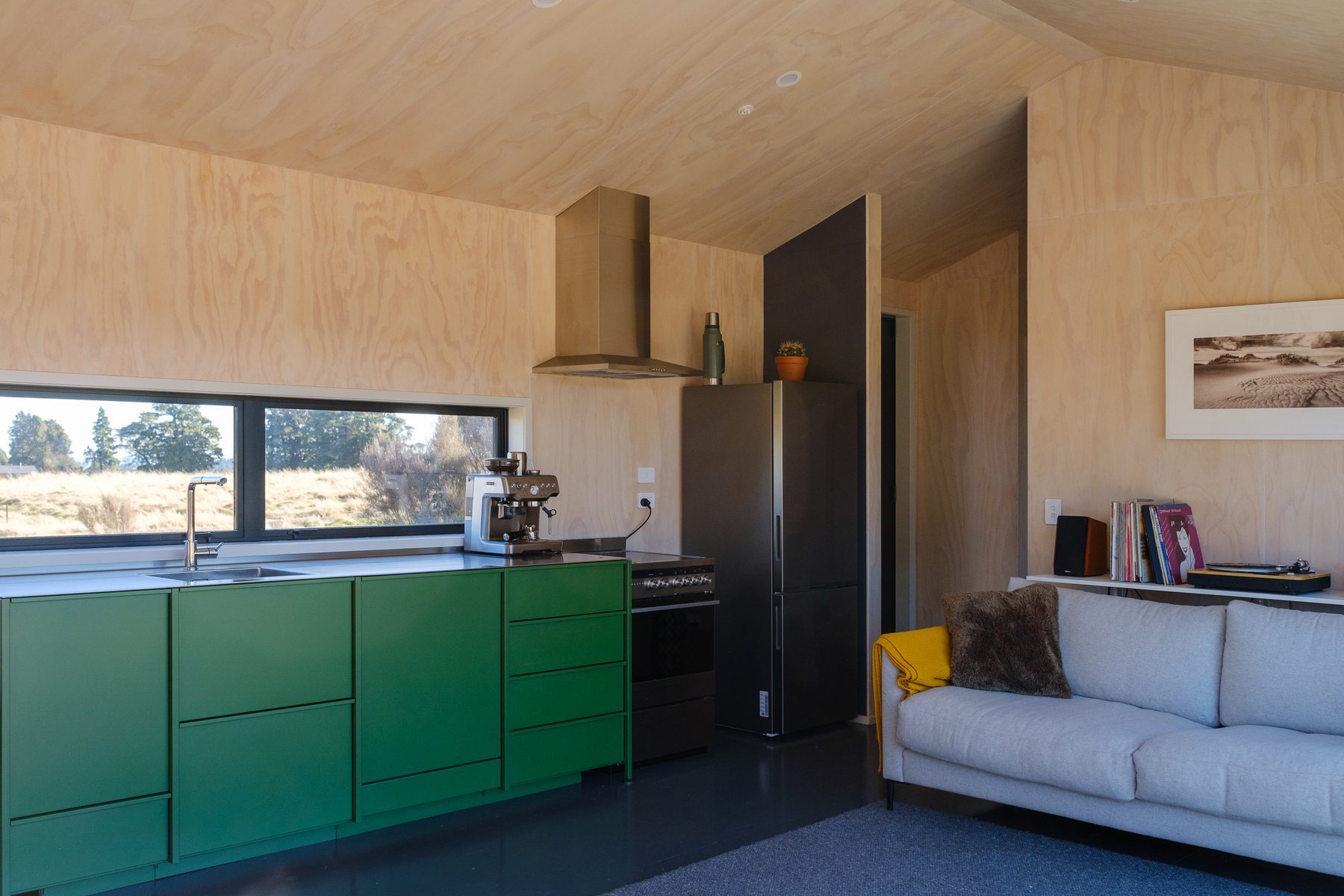 Green kitchen joinery and plywood linings.