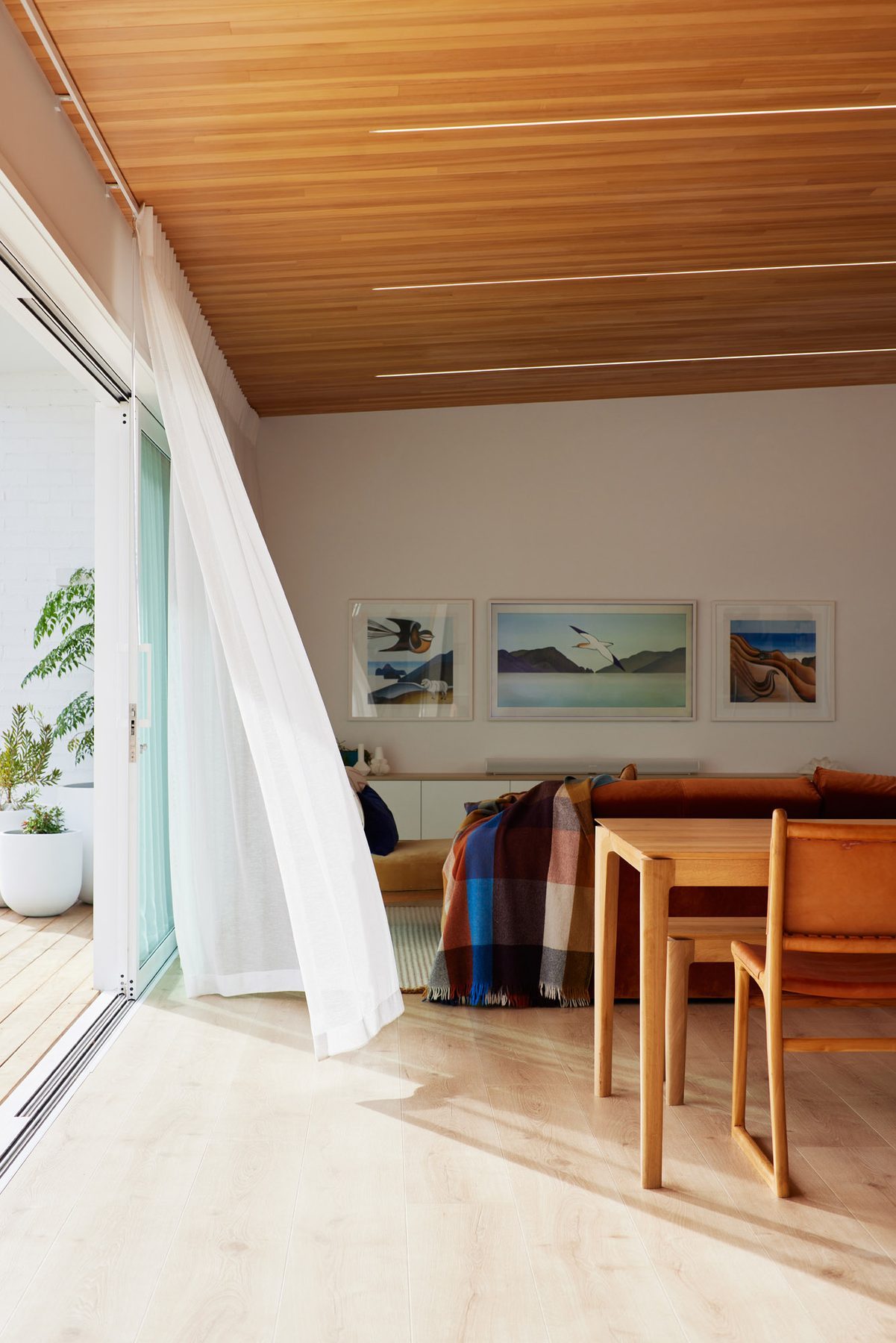 Living wing under the timber ceiling, doors to the deck.